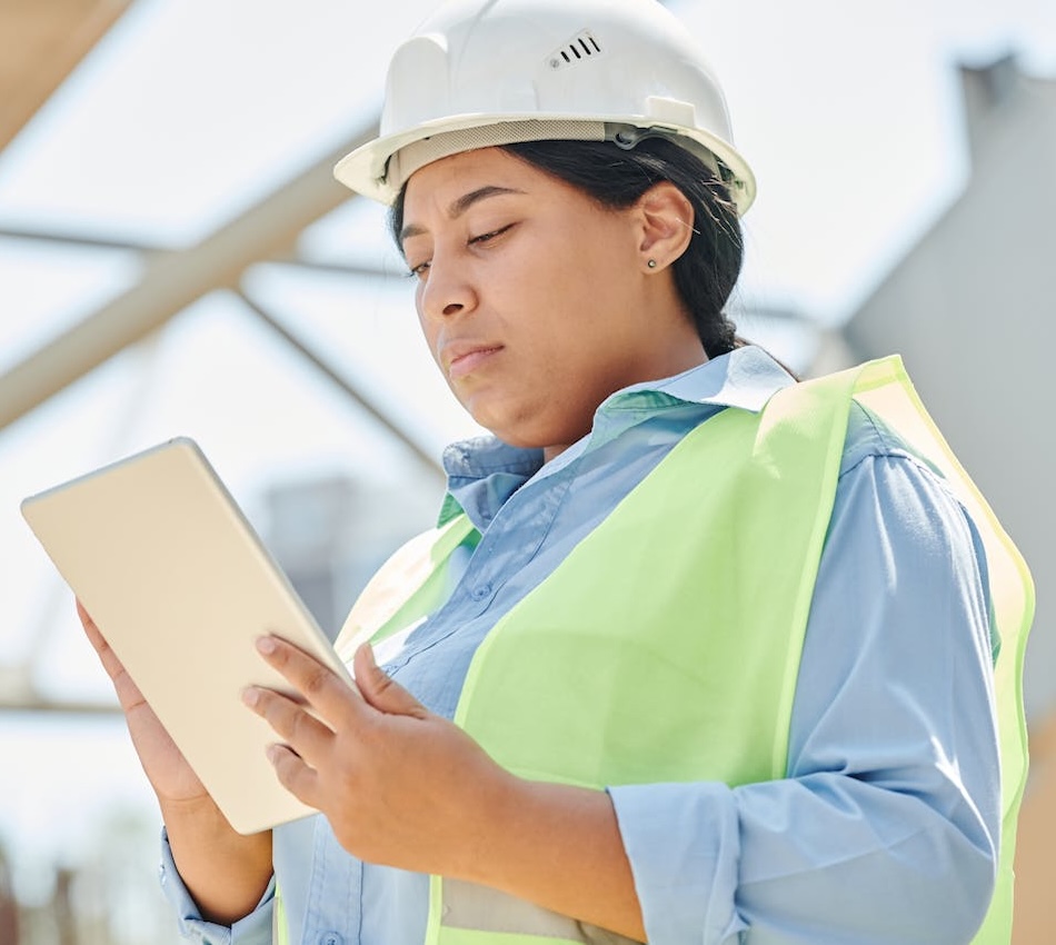 Blue collar field worker reporting on tablet